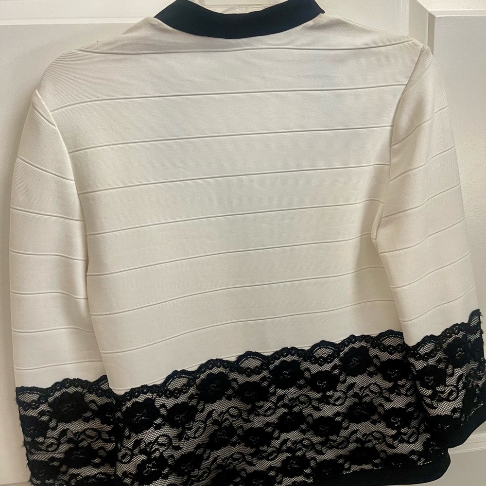Super cute black lace trimmed jacket.